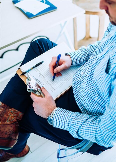 A therapist at Fort Wellness Counseling taking notes during a counseling session.