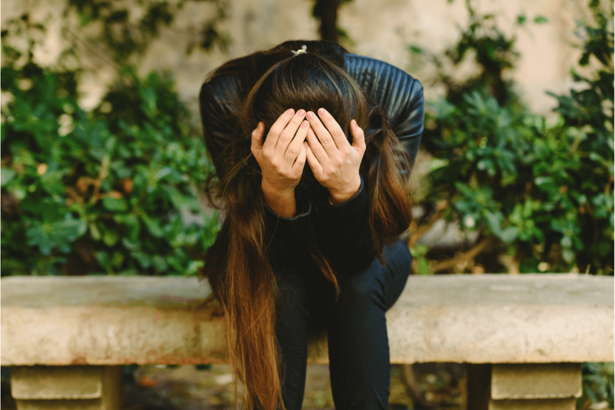 A female with her hands over her head