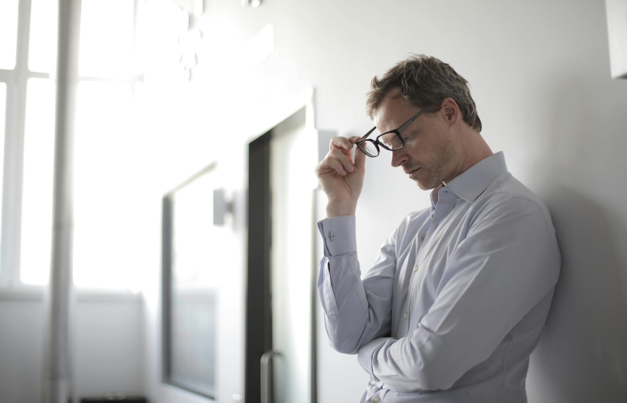 a man against a wall overthinking